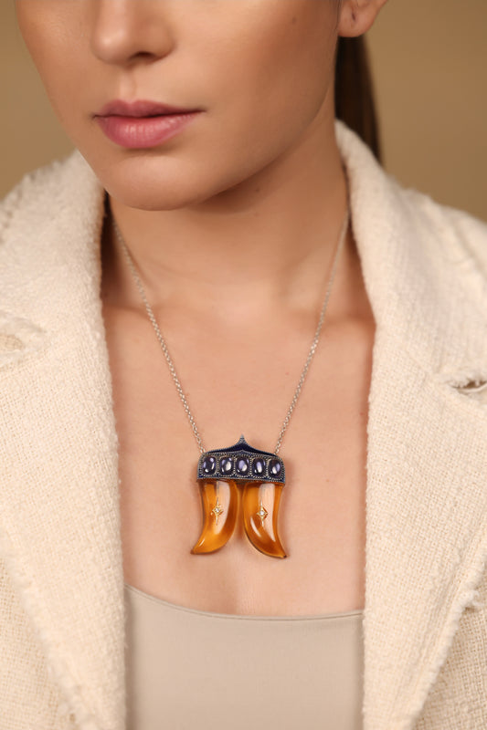 Close-up of the Rio Pendant showing the crafted kyanite and topaz stones set within the double Vagh Nakh silhouette