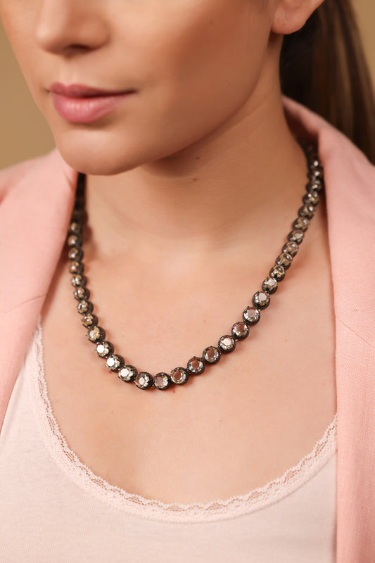Close-up of the faceted citrine stones on the Swati Necklace, each set in continuous silver brilliance