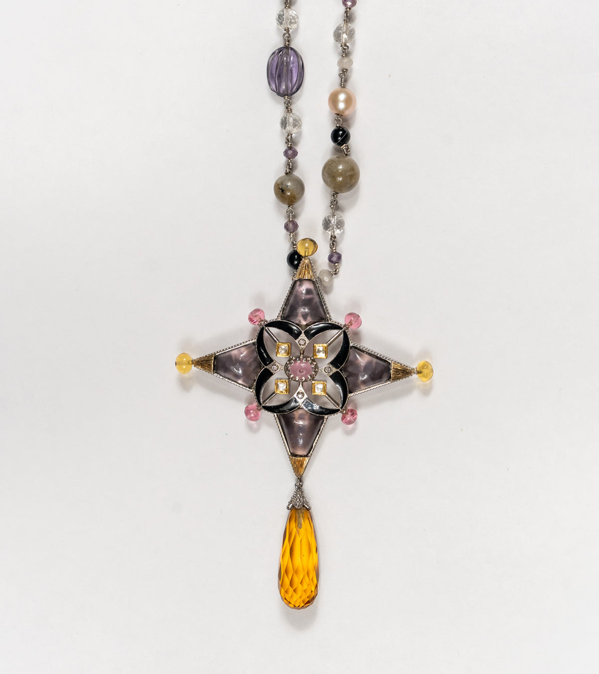 Detail of the beaded chain of pearls and natural stones on the Aashka Necklace, finishing in a topaz drop