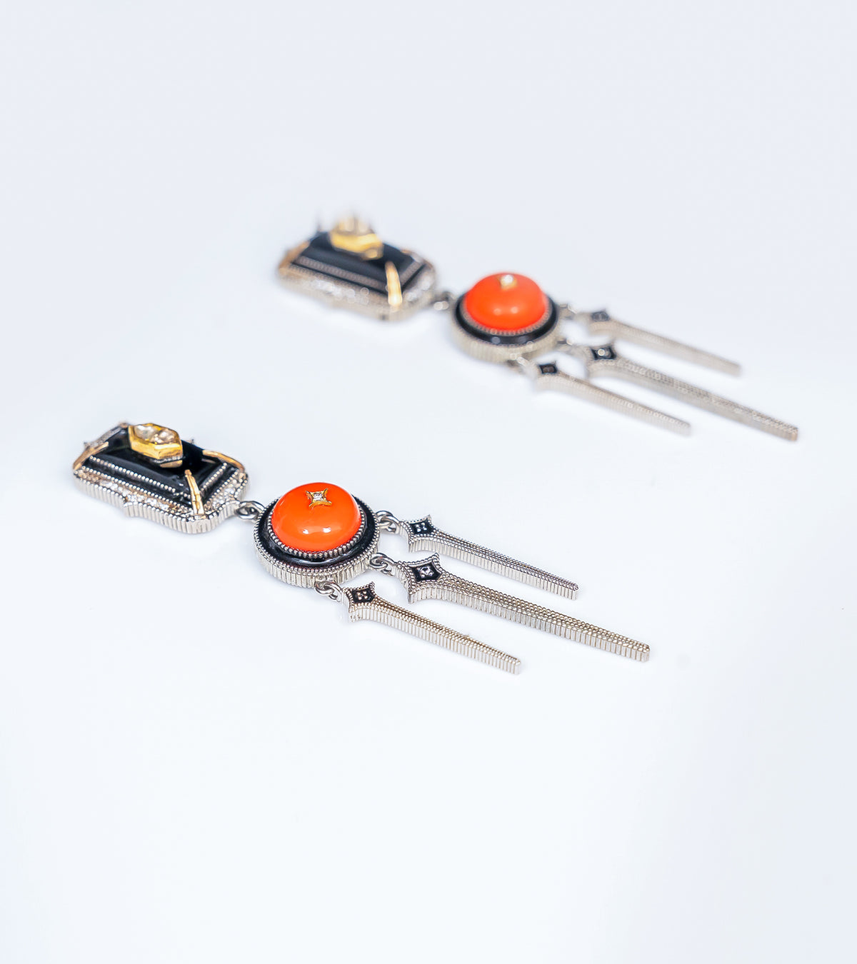 Detail of the crafted coral and gold accents on the Adel Earrings