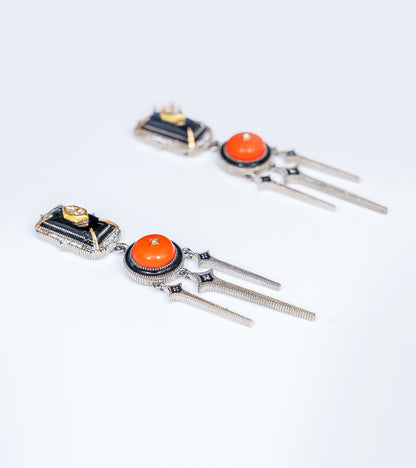 Detail of the crafted coral and gold accents on the Adel Earrings
