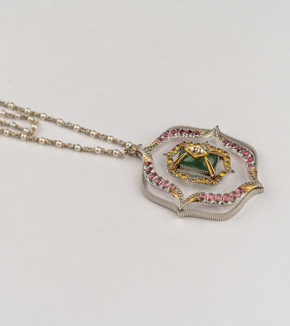 Amara Necklace with a long double strand of crafted pearls in silver wire, leading to an architectural pendant with crafted stones and a gold star motif