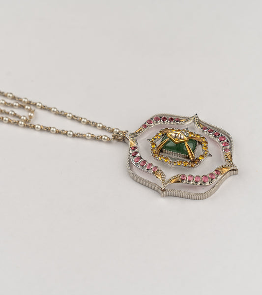 Amara Necklace with a long double strand of crafted pearls in silver wire, leading to an architectural pendant with crafted stones and a gold star motif