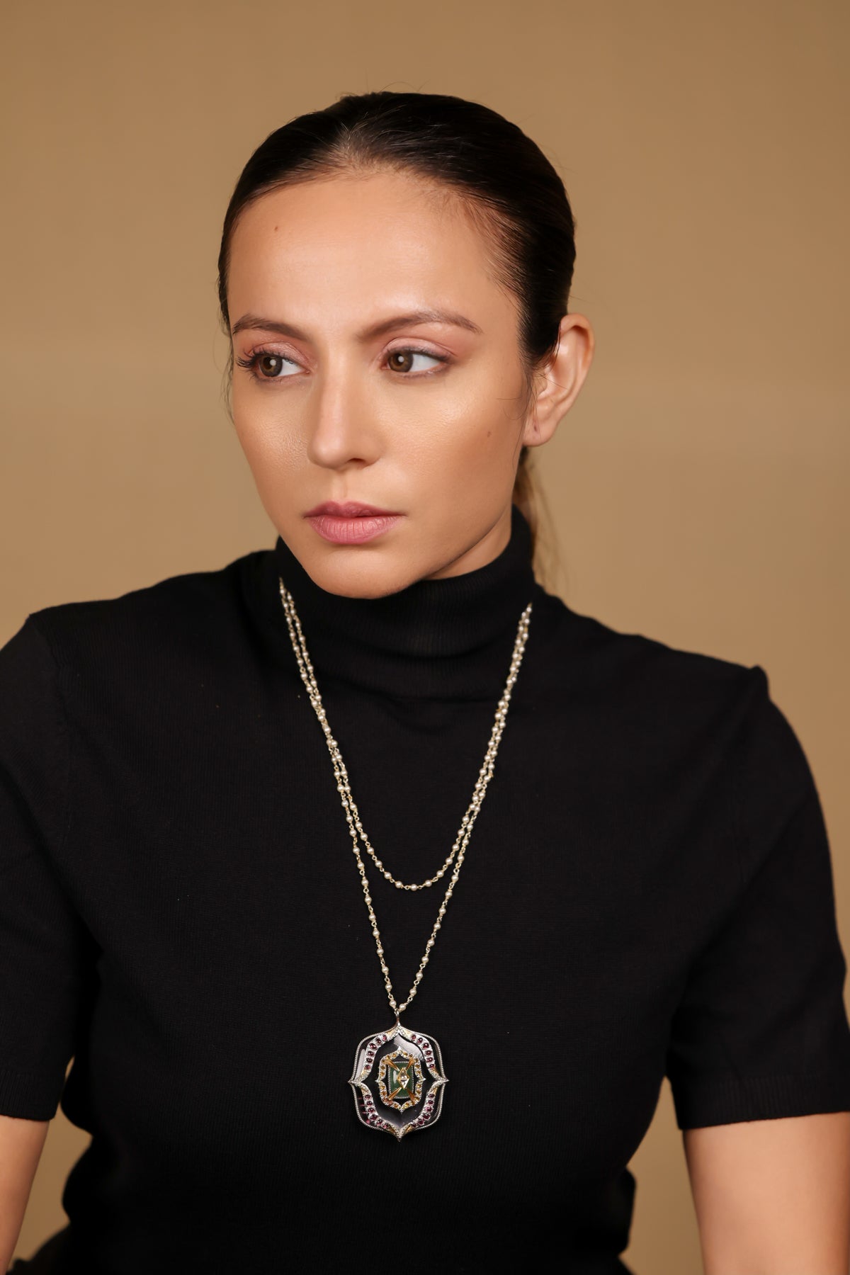 Close-up of the architectural silver pendant on the Amara Necklace, set with clear quartz, aventurine, citrine, and tourmaline