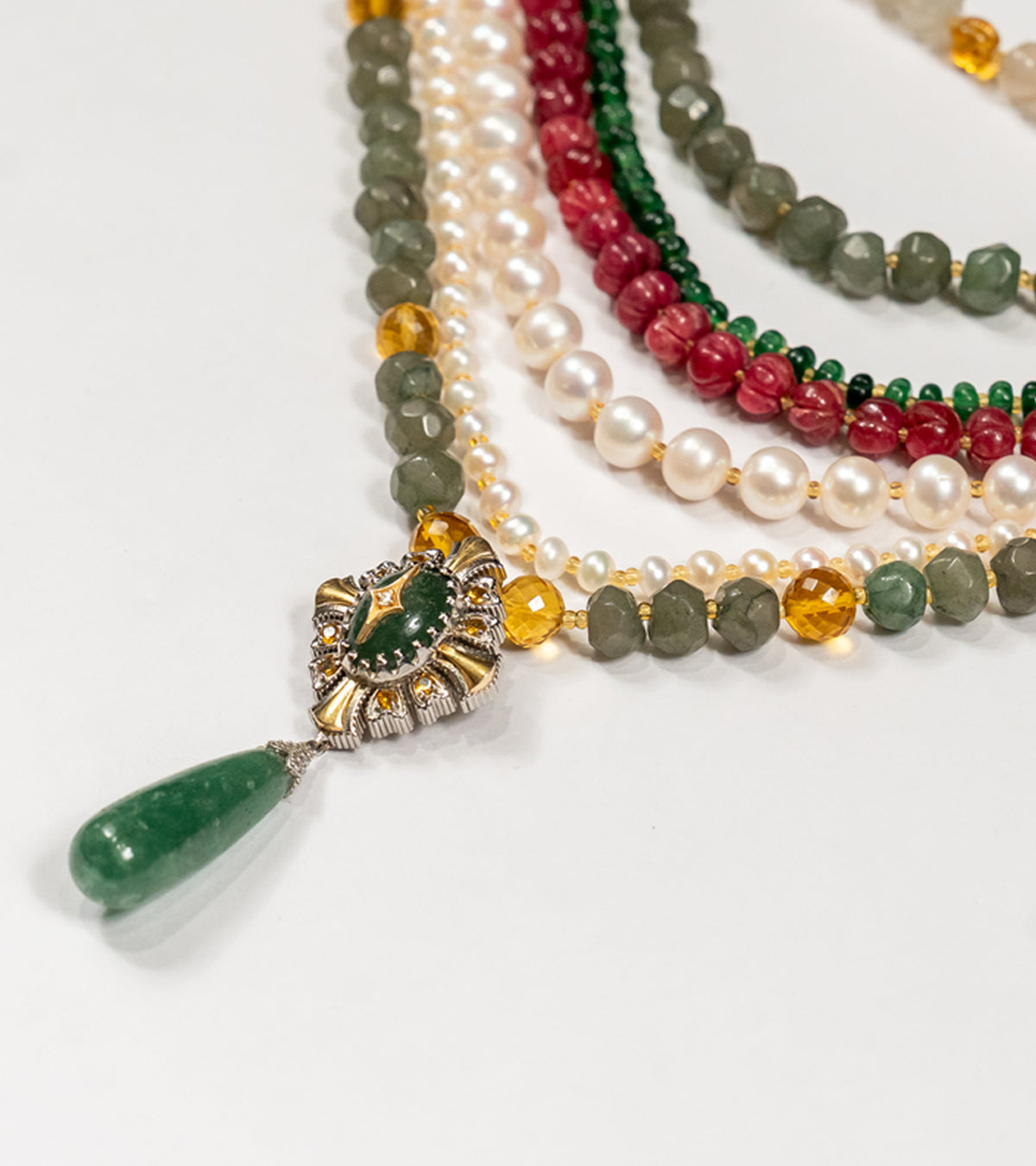 Detail of the gold and aventurine pendant on the Anuradha Necklace