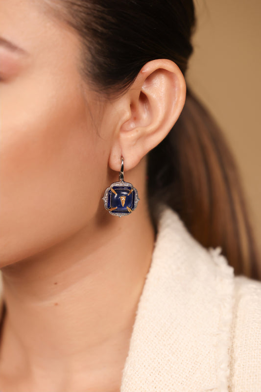 Angled view of Aurora Earrings showing the hand-painted blue enamel finish and 18K gold detailing