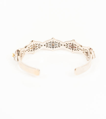 Bombay Slim cuff worn alone on the wrist, paired with delicate rings for an everyday look