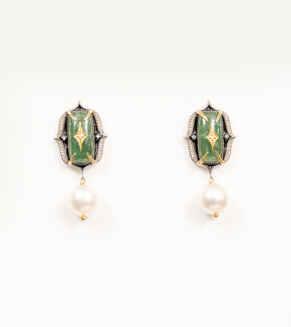 Close-up of the green stone and diamond detailing on the Rewa Earrings' green colorway