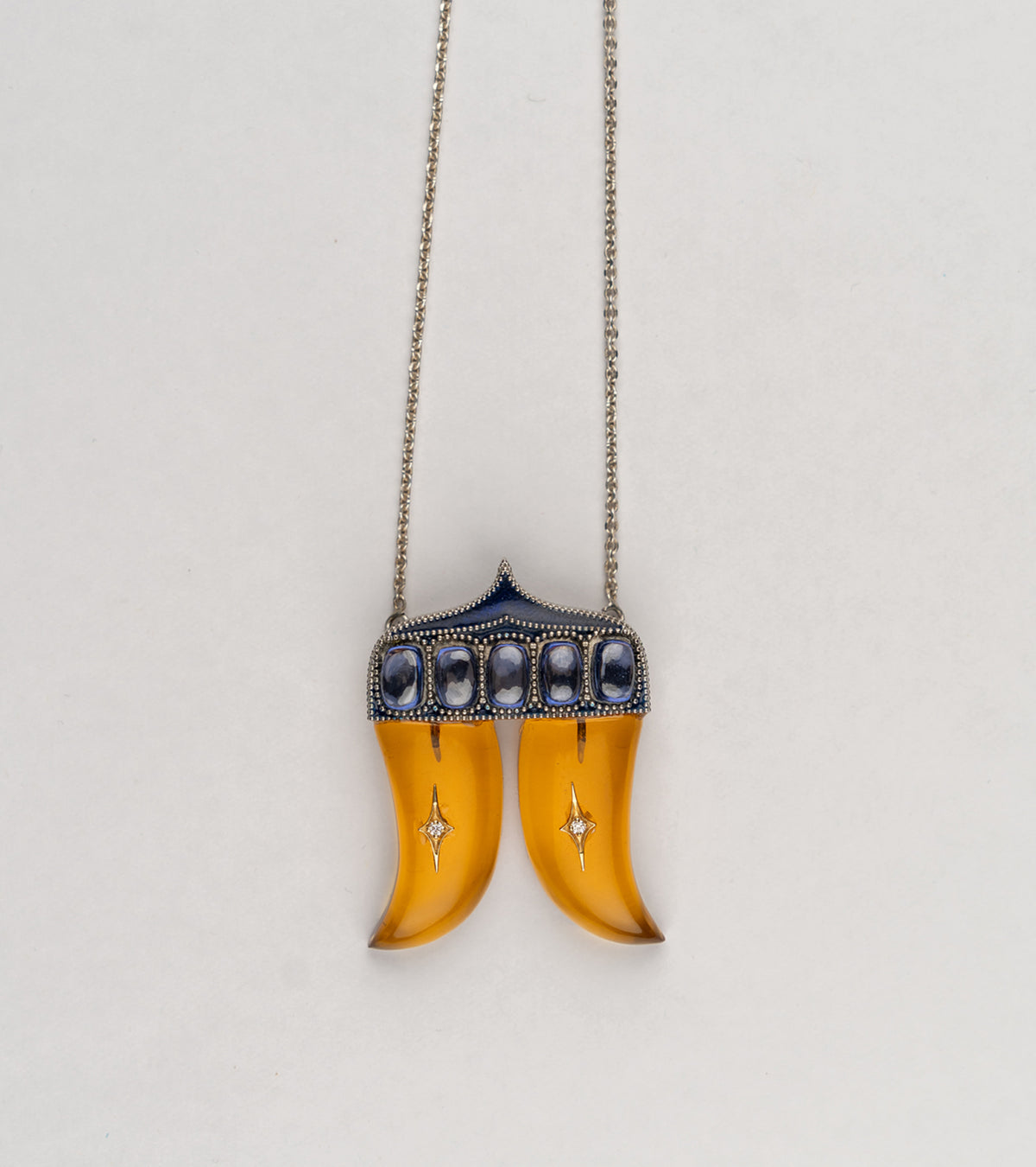 Rio Pendant inspired by the double Vagh Nakh motif, handcrafted in sterling silver with 18K gold accents, natural diamonds, and blue hand-painted enamel