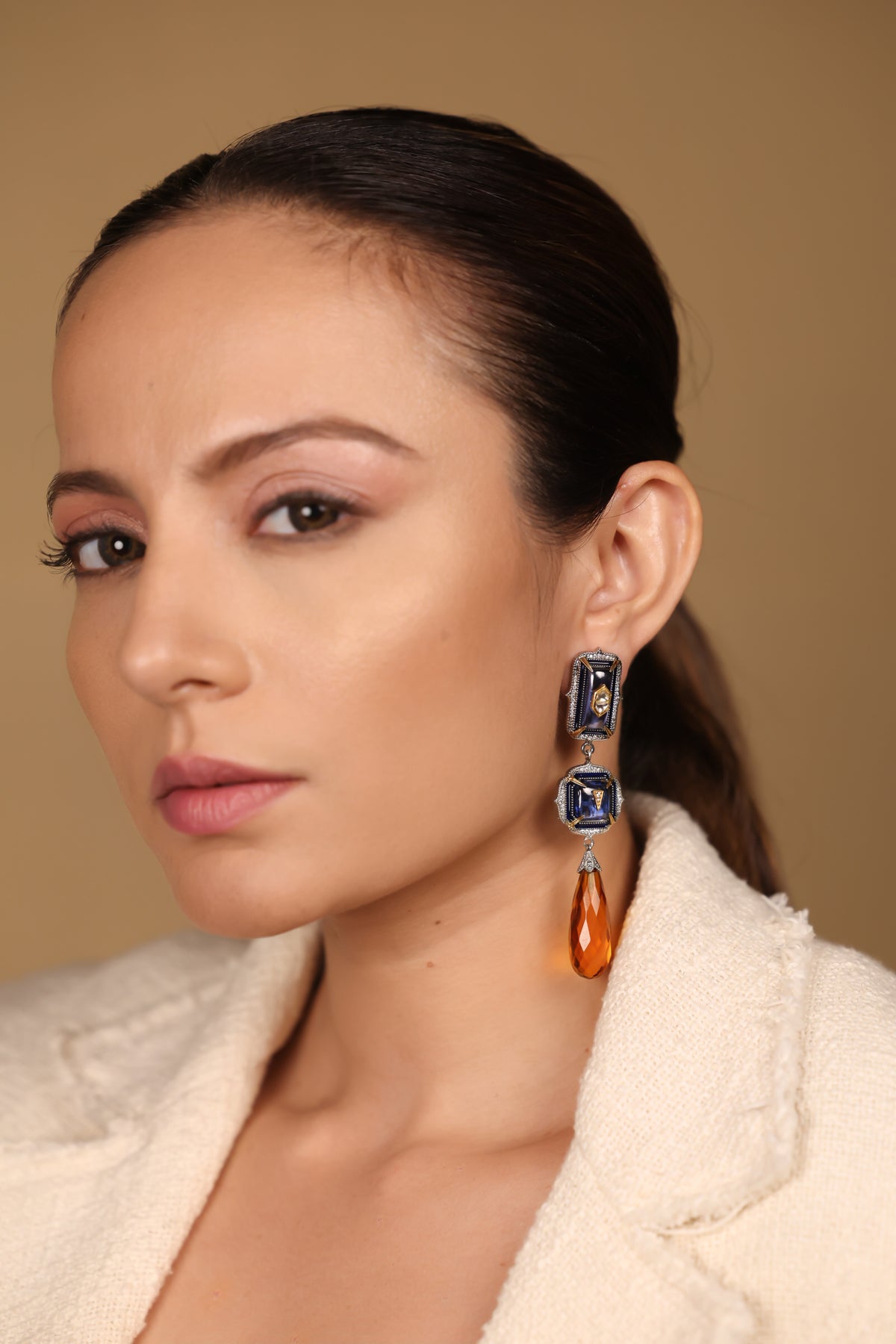 Rumi Earrings worn with sleek hair and a clean neckline, showing their length and movement