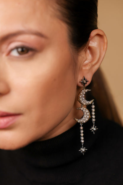 Close-up of the diamond-set star motif and black enamel detailing on the Sana Earrings