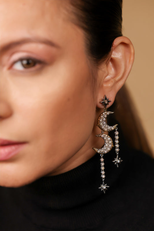 Close-up of the diamond-set star motif and black enamel detailing on the Sana Earrings