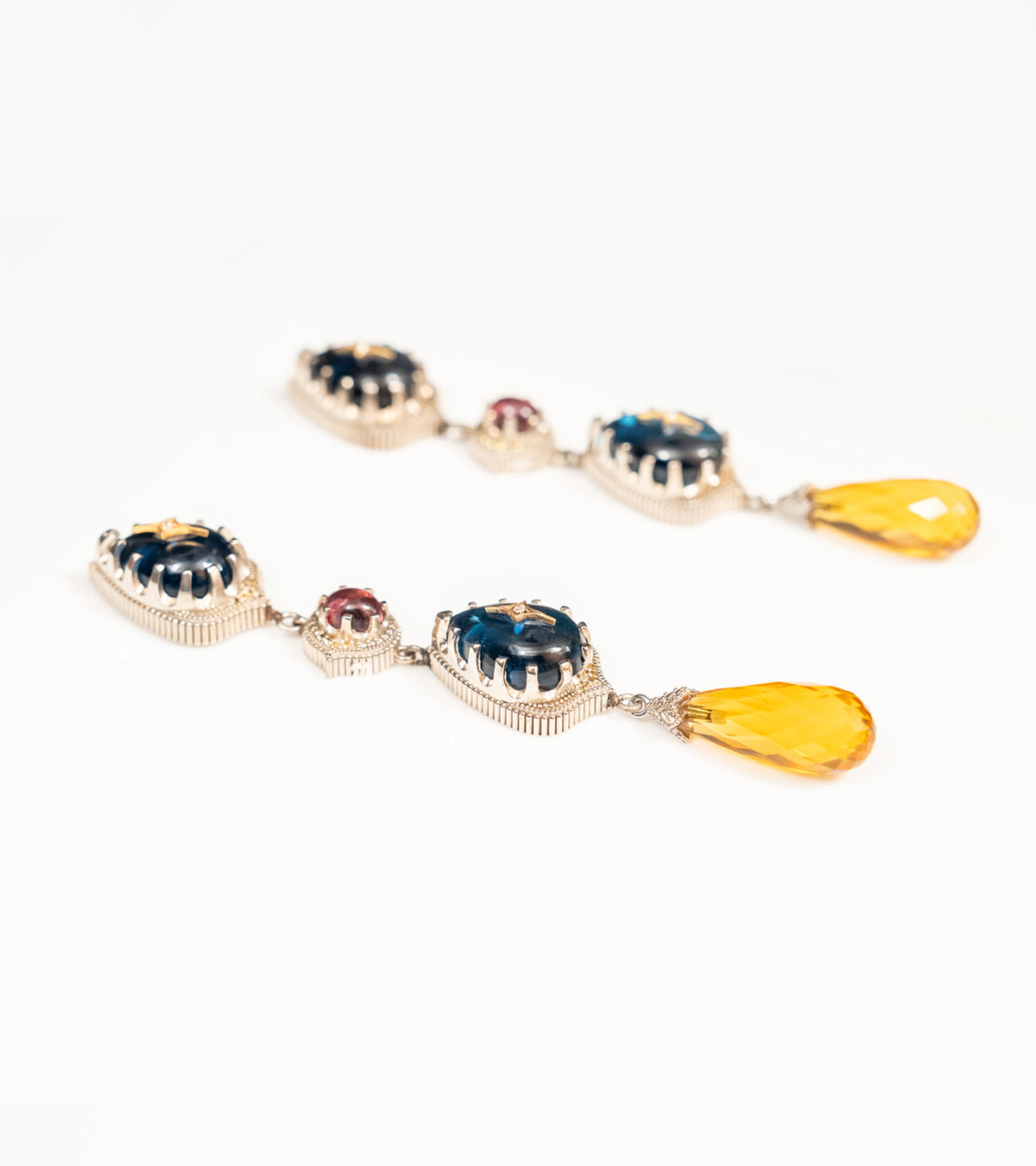 Detail shot of the Sara Earrings highlighting the black hand-painted enamel finish and diamond accents