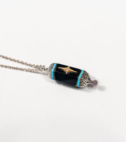 Detail of the hand-painted turquoise enamel accent on the Sirius Pendant