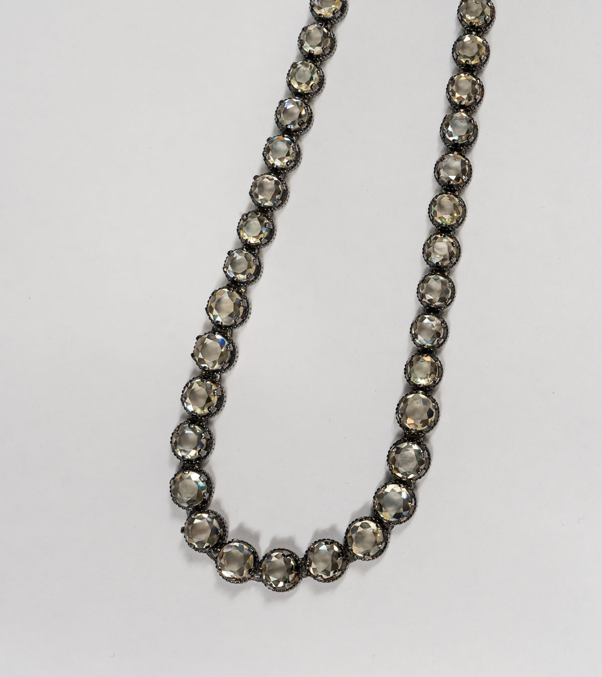 Detail shot of the Swati Necklace showing the silver setting and continuous line of citrine stones