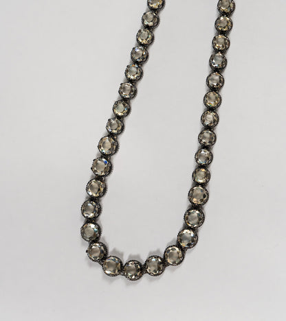 Detail shot of the Swati Necklace showing the silver setting and continuous line of citrine stones