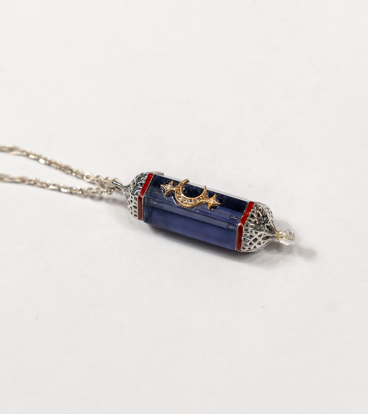 Detail of the hand-painted coral enamel accent on the Vega Pendant