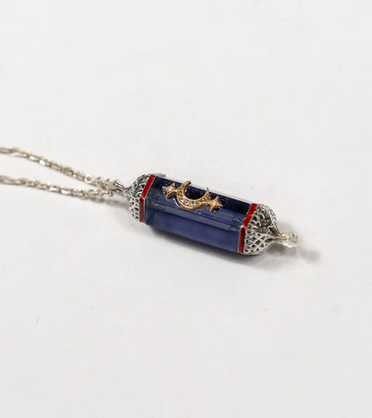 Detail of the hand-painted coral enamel accent on the Vega Pendant