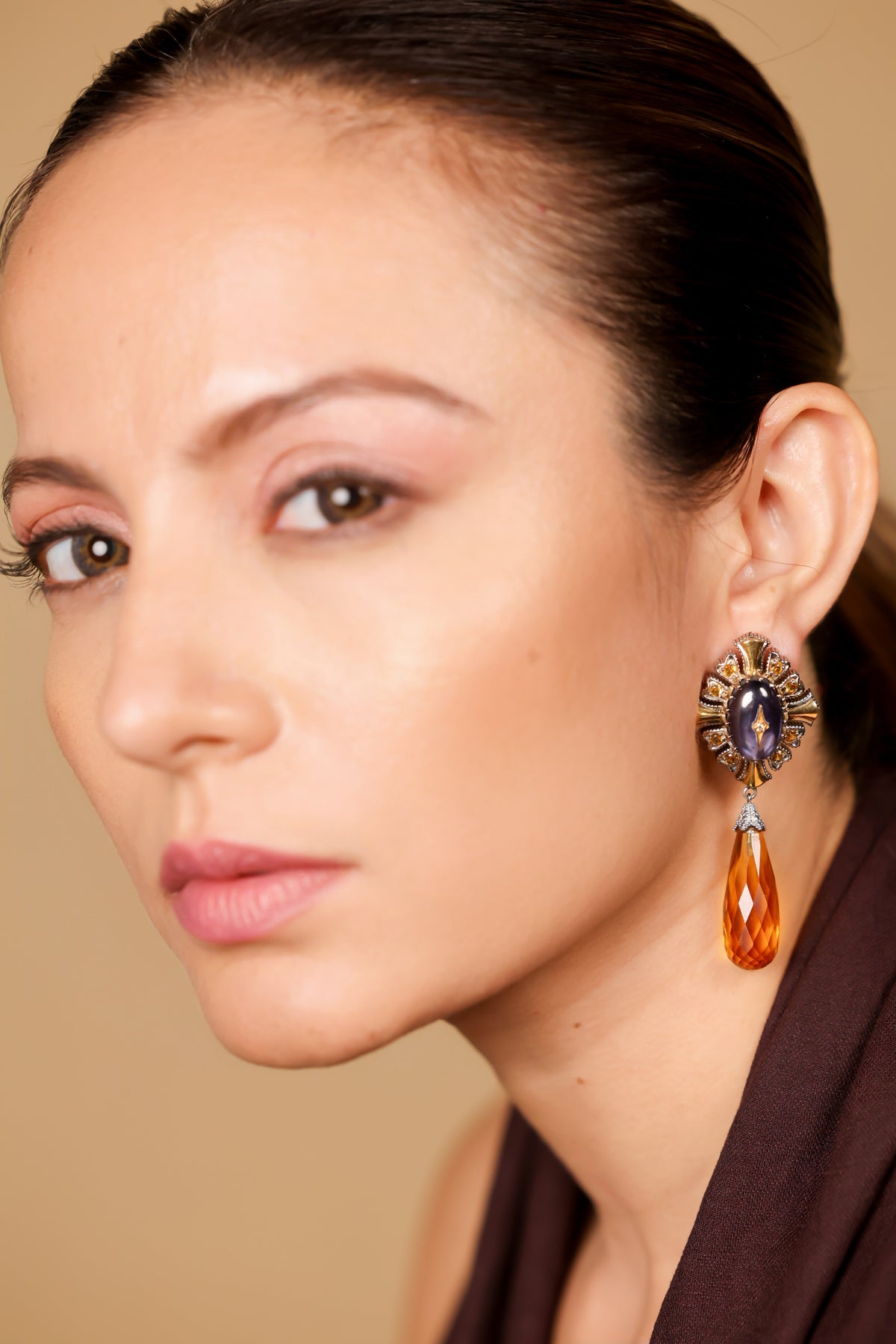 Virja Earrings worn alone with a simple neckline, letting the blue enamel take centre stage