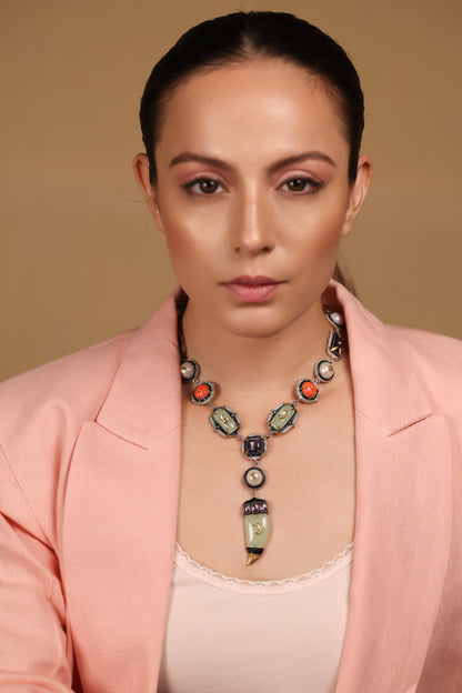 Close-up of the amethyst crystal and aqua onyx detailing on the Zuri Necklace