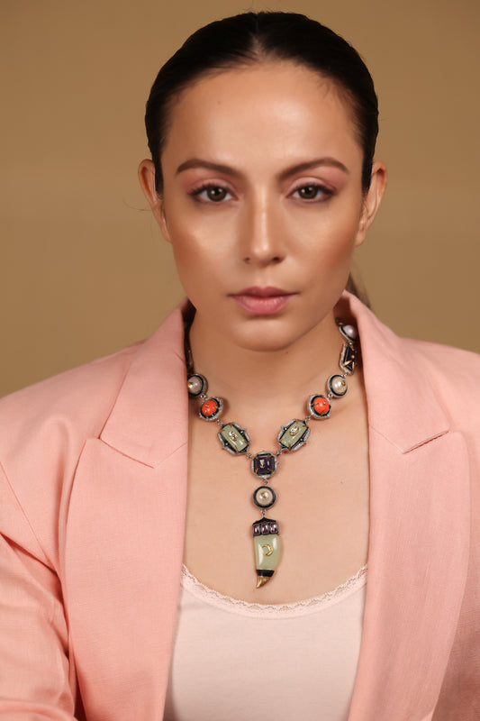 Close-up of the amethyst crystal and aqua onyx detailing on the Zuri Necklace