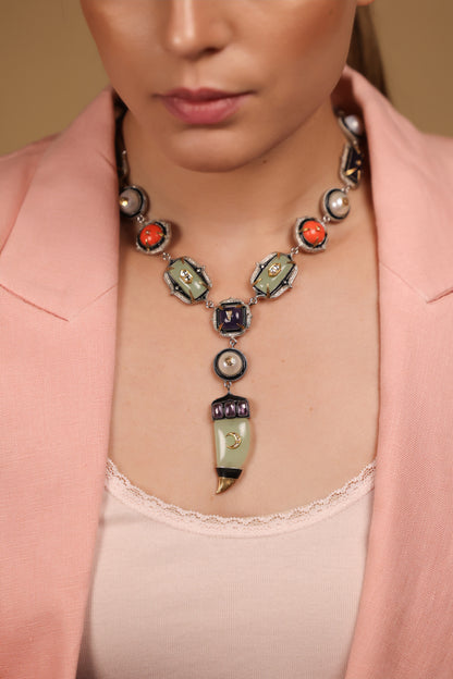 Zuri Necklace worn against a deep, dark silhouette, letting its colours take centre stage